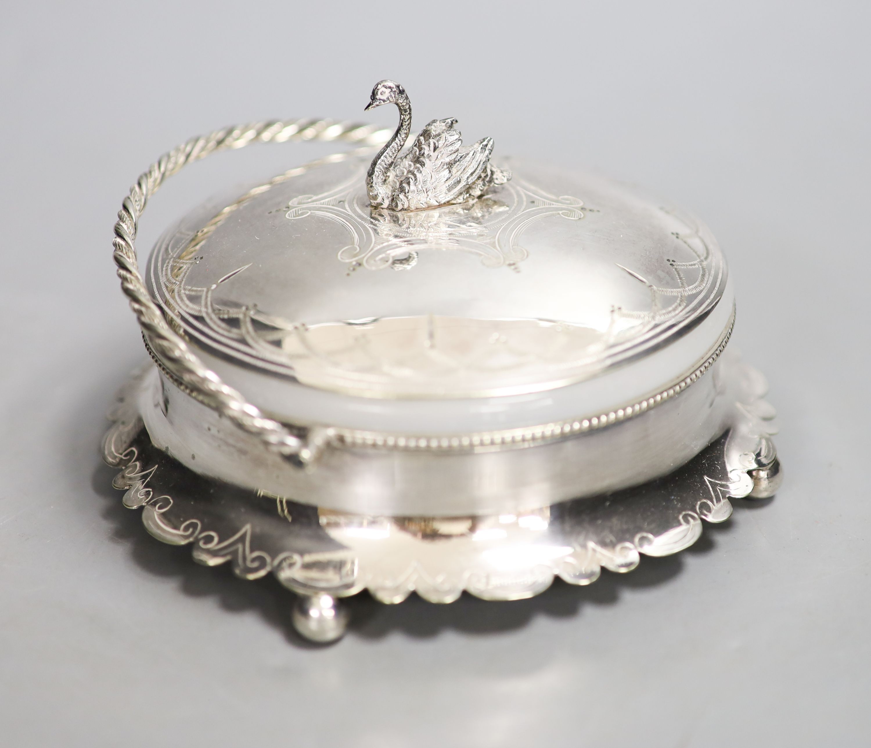 A silver plated powder box, the lid with swan finial.